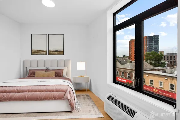 a bedroom with a bed and window