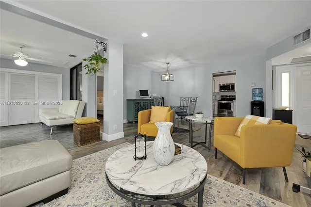 a living room with furniture a rug and a table