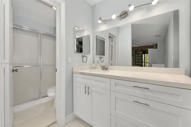 a bathroom with a double vanity sink a mirror and a bathtub