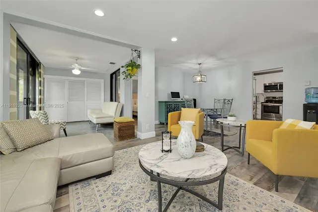 a living room with furniture and wooden floor