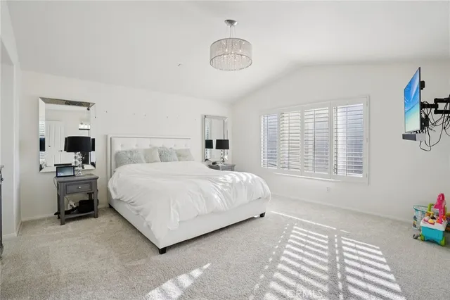 a spacious bedroom with a bed and window