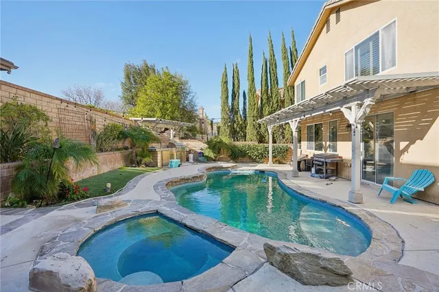 a view of a house with swimming pool and sitting area