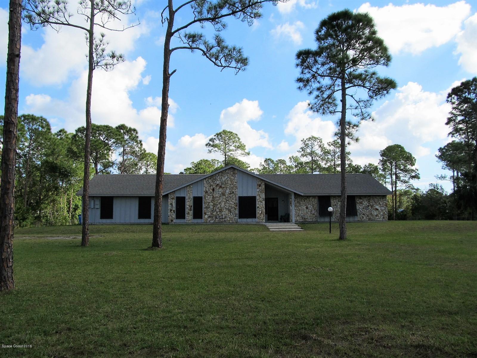 3775 Corey Road Grant Valkaria, FL 32950 - Photo 1 of 12 a front view of a house with garden