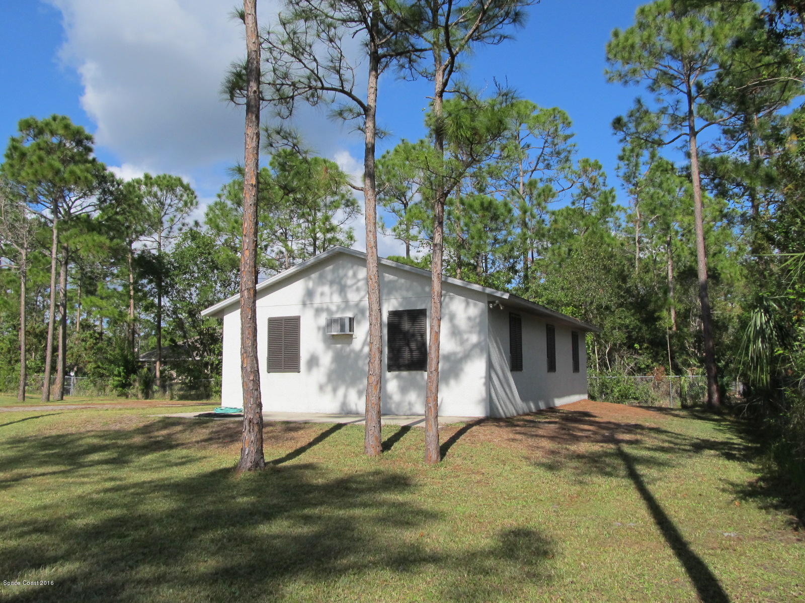 3775 Corey Road Grant Valkaria, FL 32950 - Photo 7 of 12 a backyard of a house with table and chairs