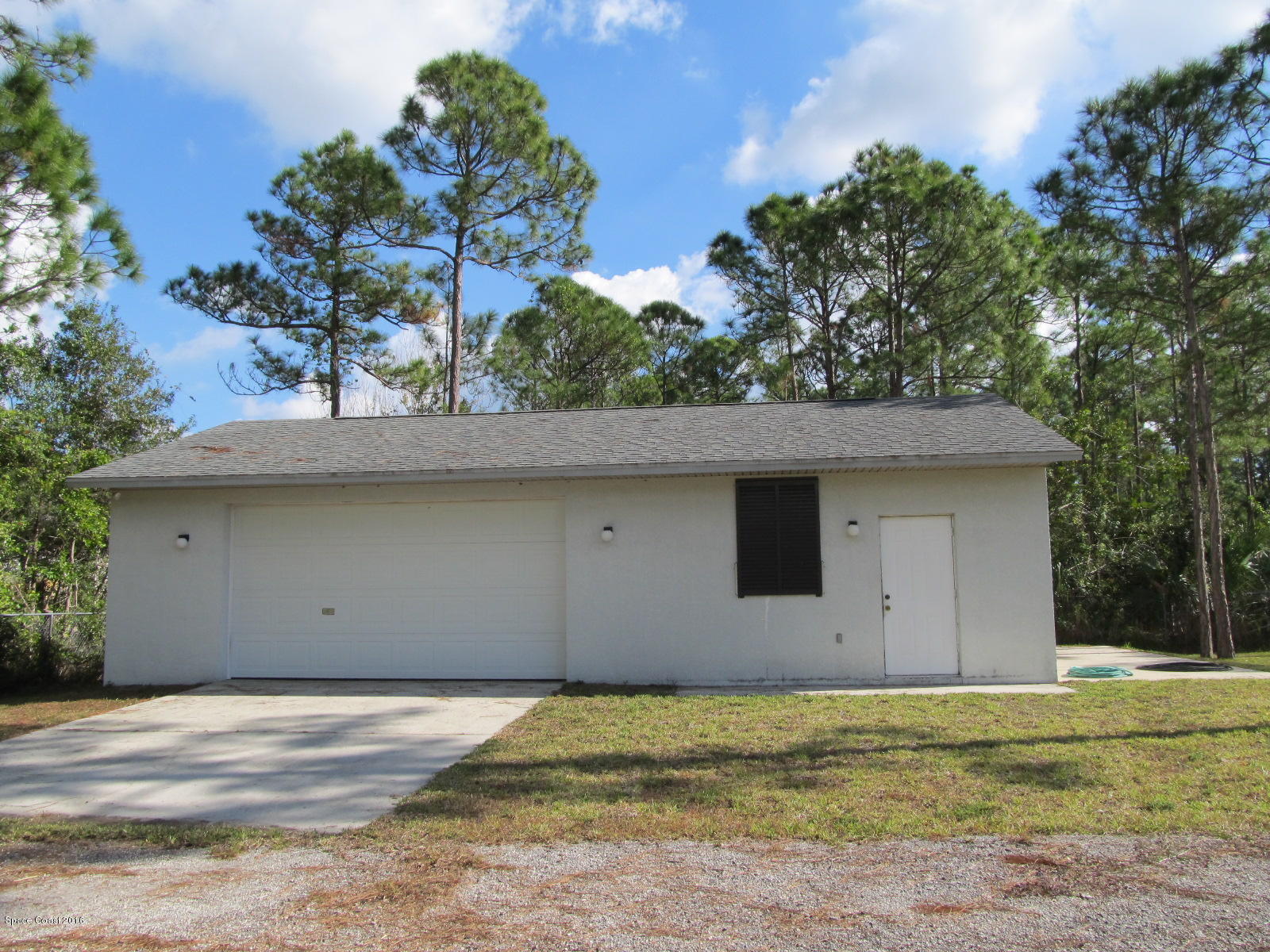 3775 Corey Road Grant Valkaria, FL 32950 - Photo 8 of 12 a front view of a house with a garden