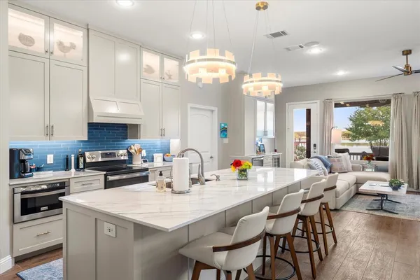 a kitchen with center island table and chairs in it