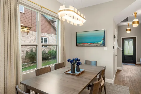 a dining room with furniture and wooden floor