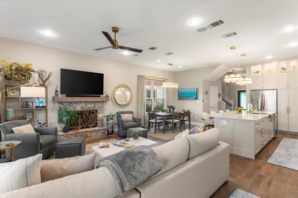 a living room with fireplace furniture and a flat screen tv