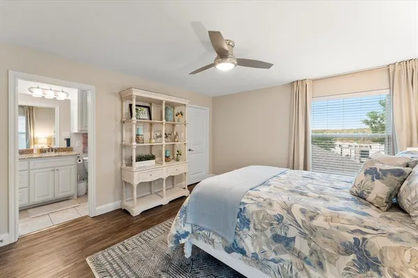 a bedroom with a large bed and a window