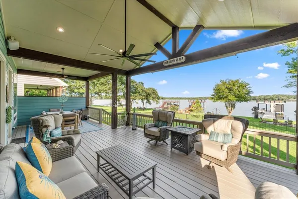 a roof deck with table and chairs and potted plants