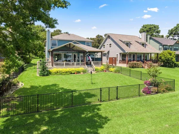 a view of a house with a big yard and potted plants