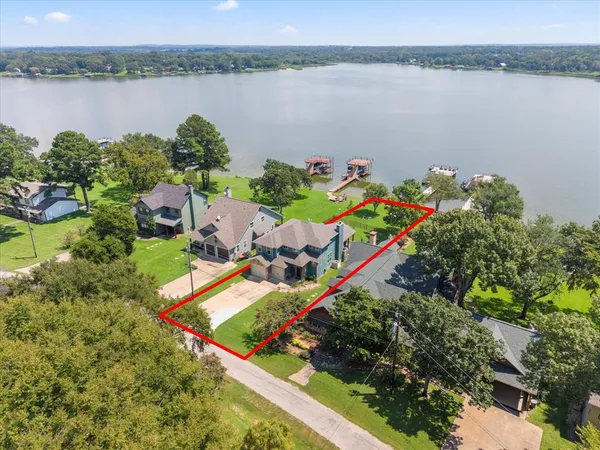 an aerial view of a house with a lake view