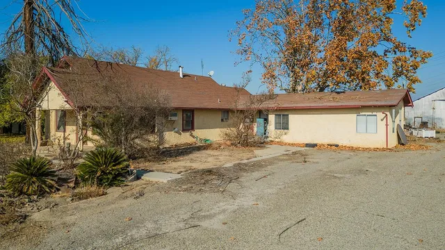 a view of a house with a tree in front