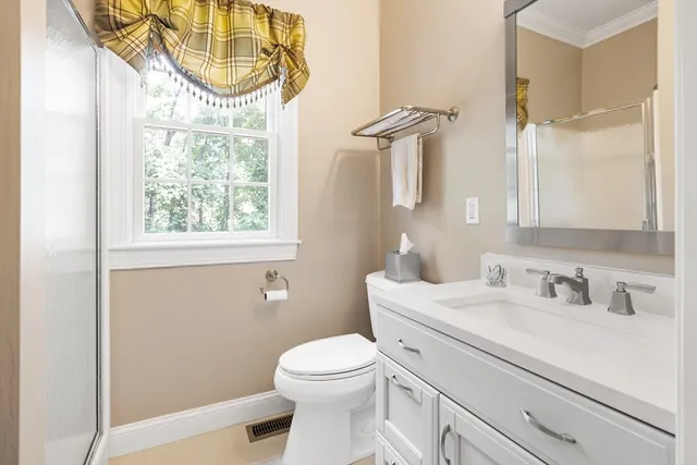 a bathroom with a sink a toilet and a mirror