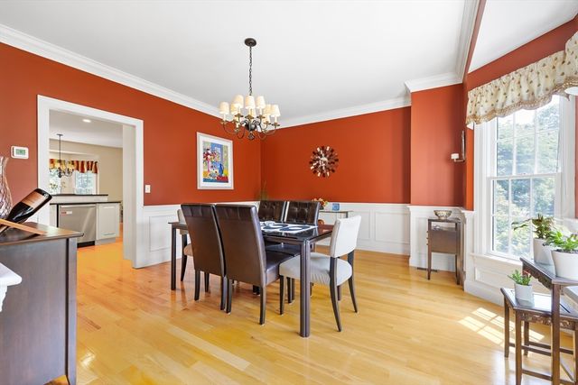 a view of a dining room with furniture and chandelier
