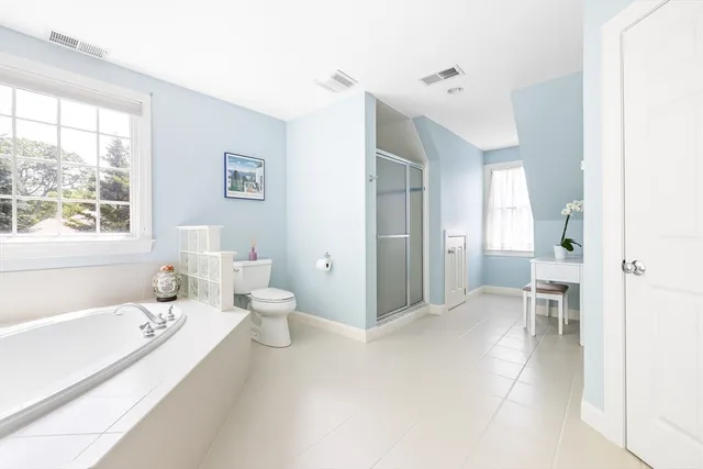 a spacious bathroom with a bathtub sink and toilet