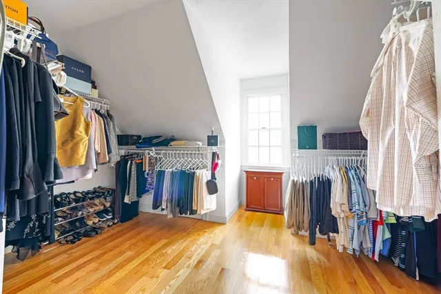 a view of walk in closet with clothes and shoes