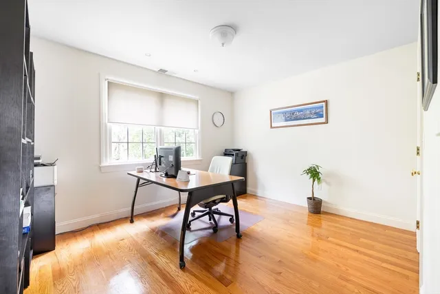 a workspace with furniture window and wooden floor
