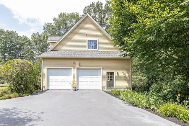 a view of a house with a yard and garage