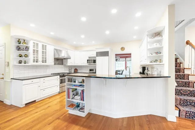 a kitchen with stainless steel appliances granite countertop a stove and a sink