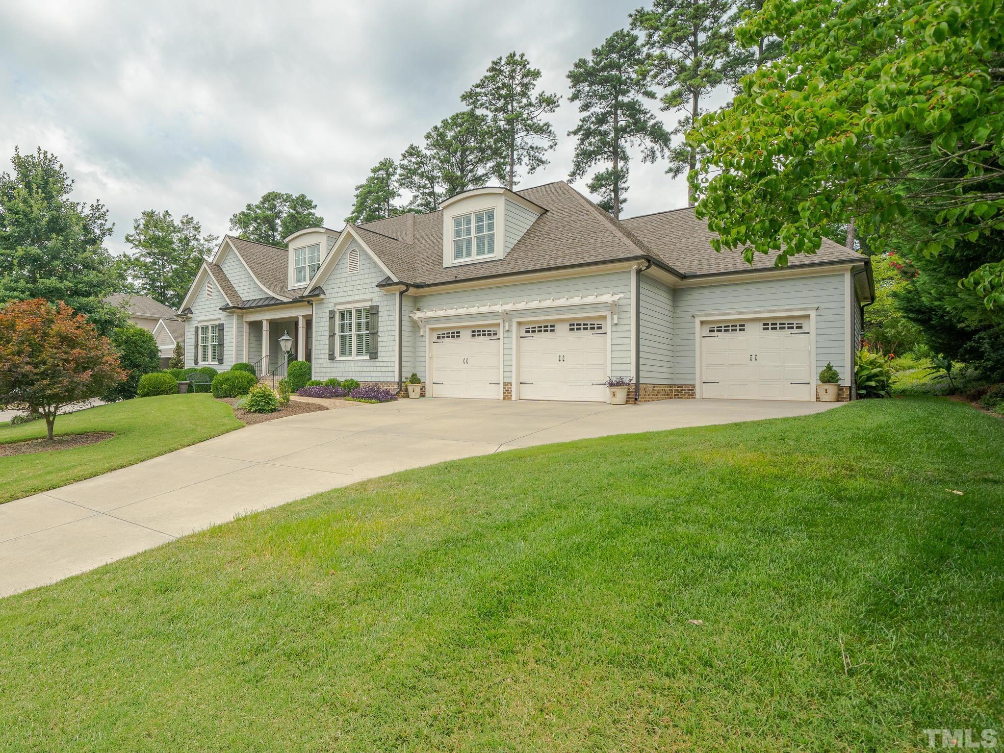 842 Cranbrook Road Raleigh, NC 27609 - Photo 1 of 39 a front view of a house with a garden and trees