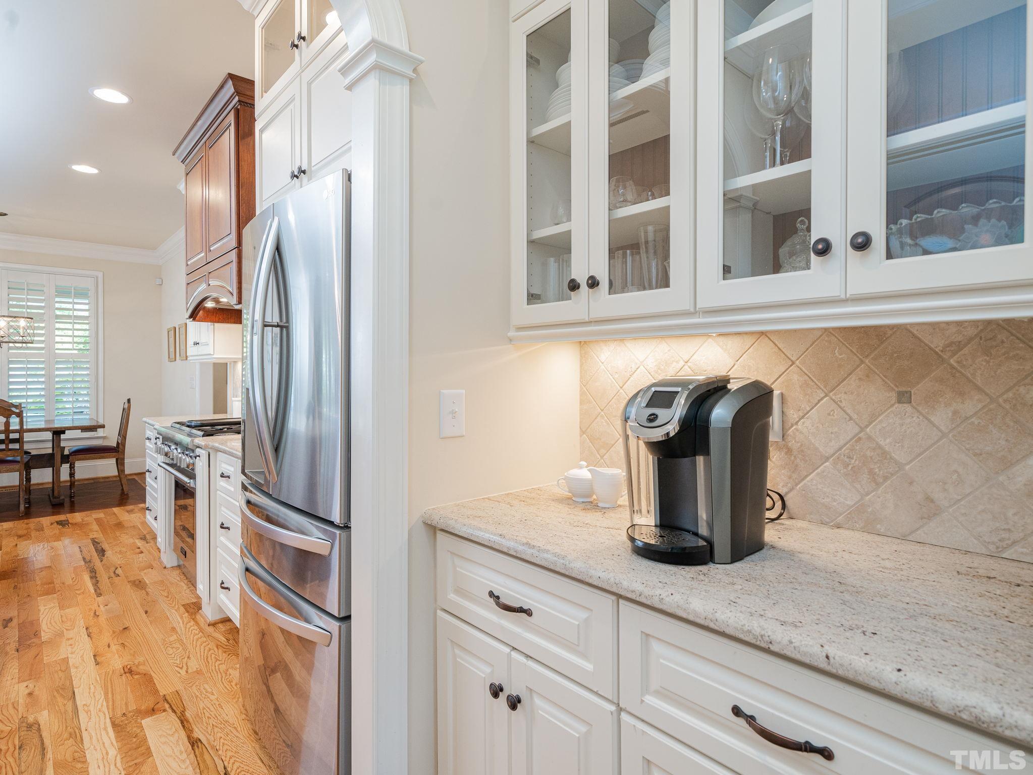 842 Cranbrook Road Raleigh, NC 27609 - Photo 11 of 39 a kitchen with granite countertop a sink and a refrigerator