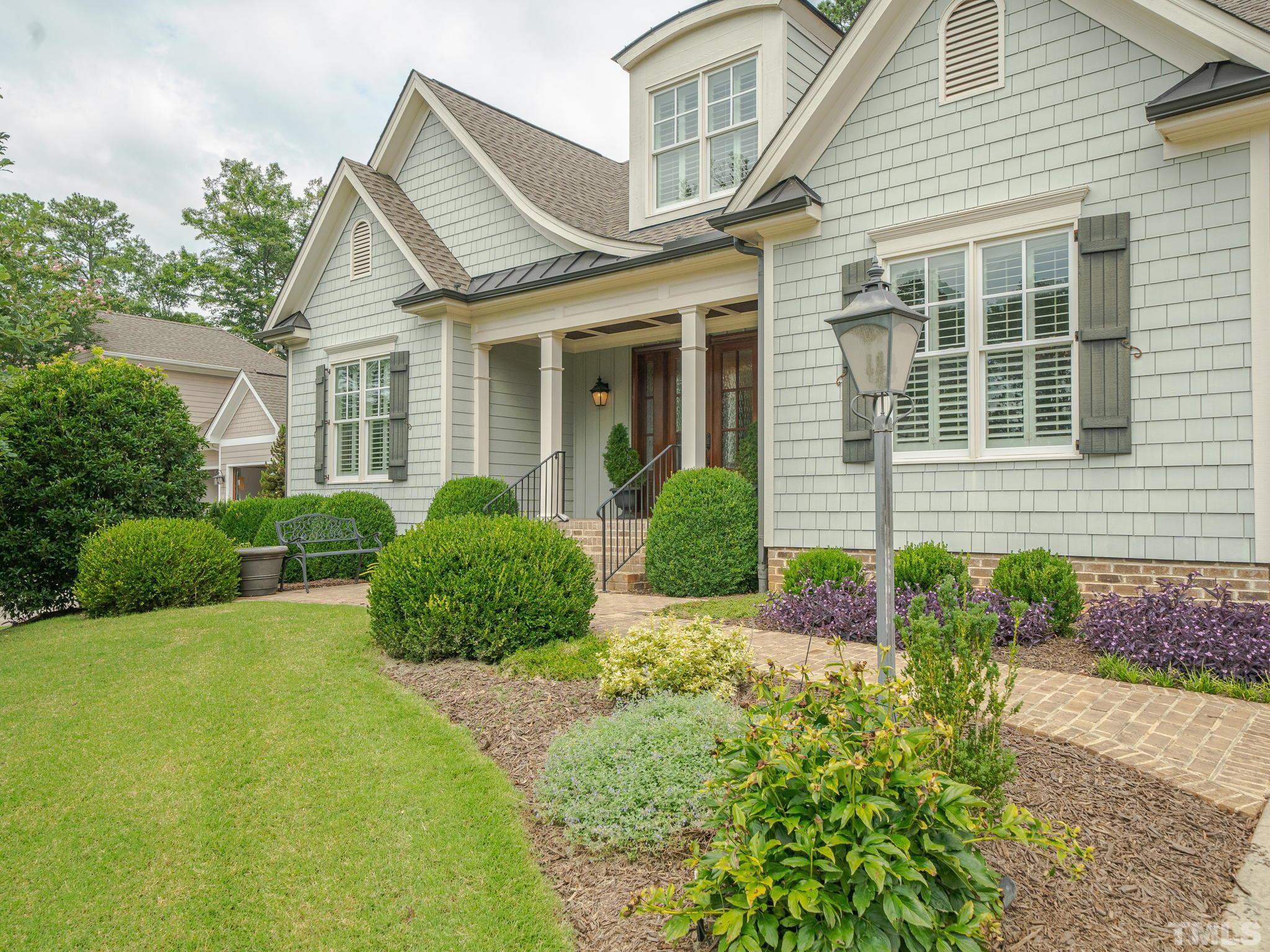 842 Cranbrook Road Raleigh, NC 27609 - Photo 2 of 39 a front view of a house with garden