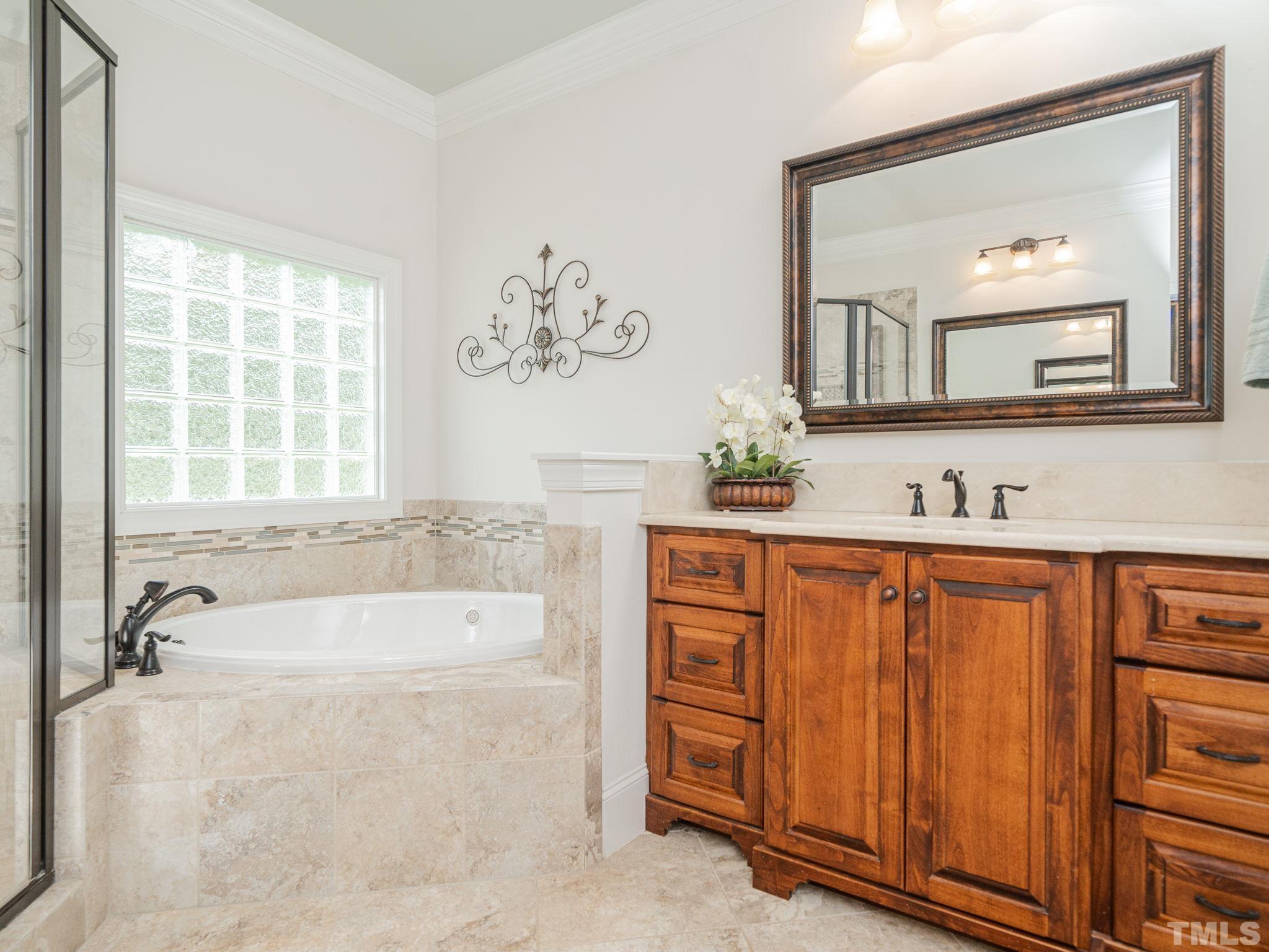 842 Cranbrook Road Raleigh, NC 27609 - Photo 23 of 39 a bathroom with a tub sink and mirror