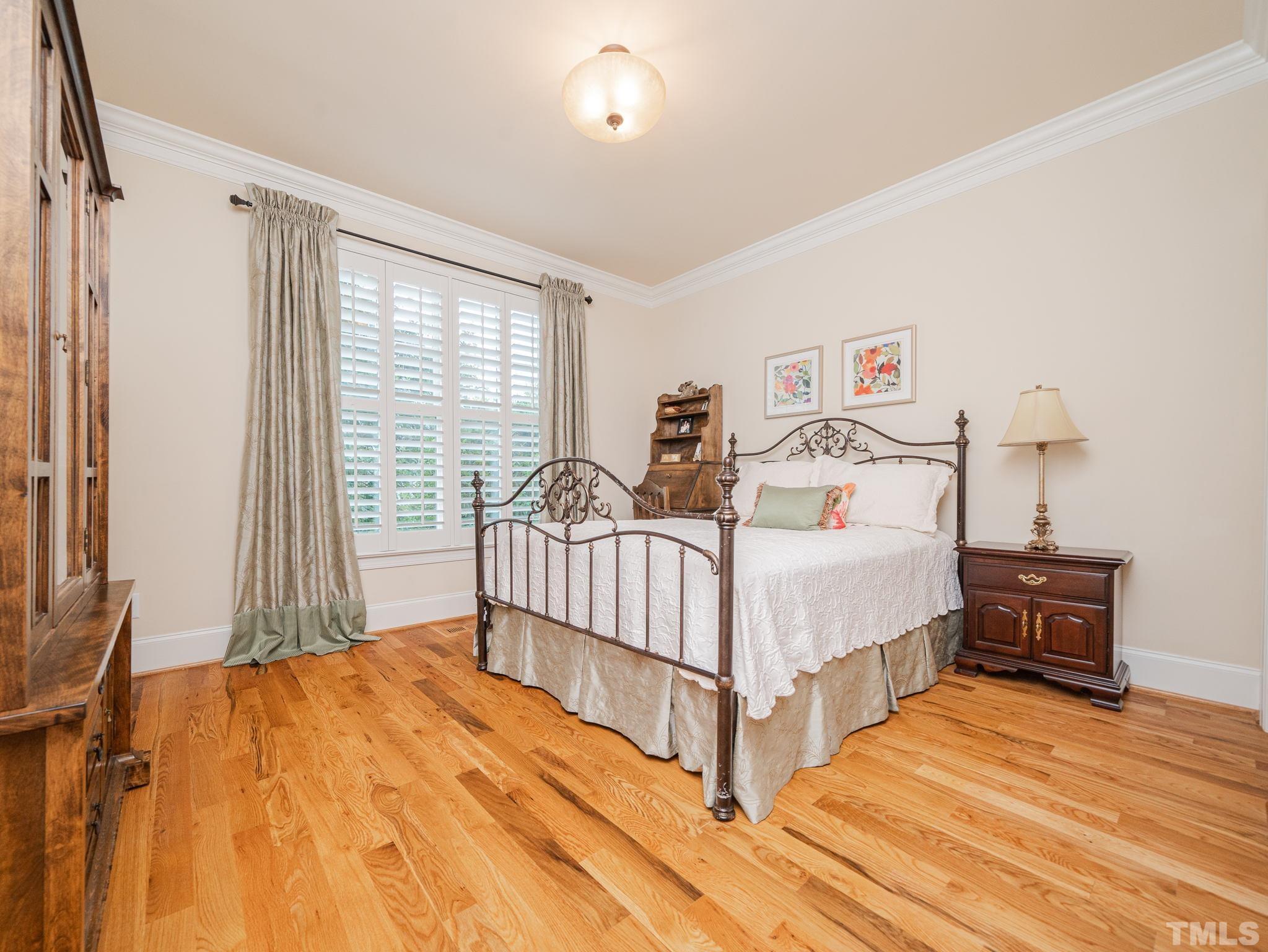 842 Cranbrook Road Raleigh, NC 27609 - Photo 24 of 39 a bedroom with a bed and a night stand