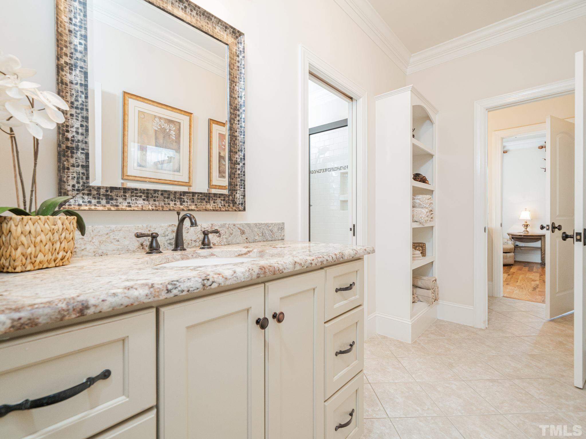 842 Cranbrook Road Raleigh, NC 27609 - Photo 25 of 39 a bathroom with a granite countertop sink and a mirror