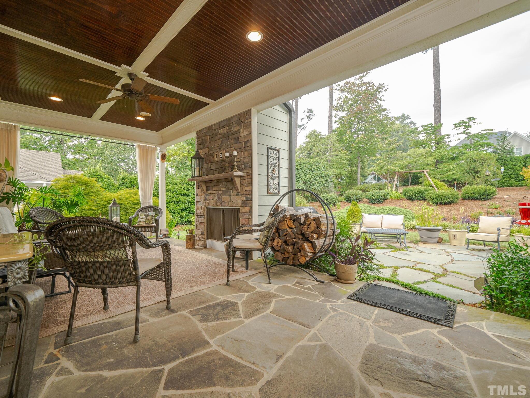 842 Cranbrook Road Raleigh, NC 27609 - Photo 33 of 39 a living room with patio furniture and a floor to ceiling window