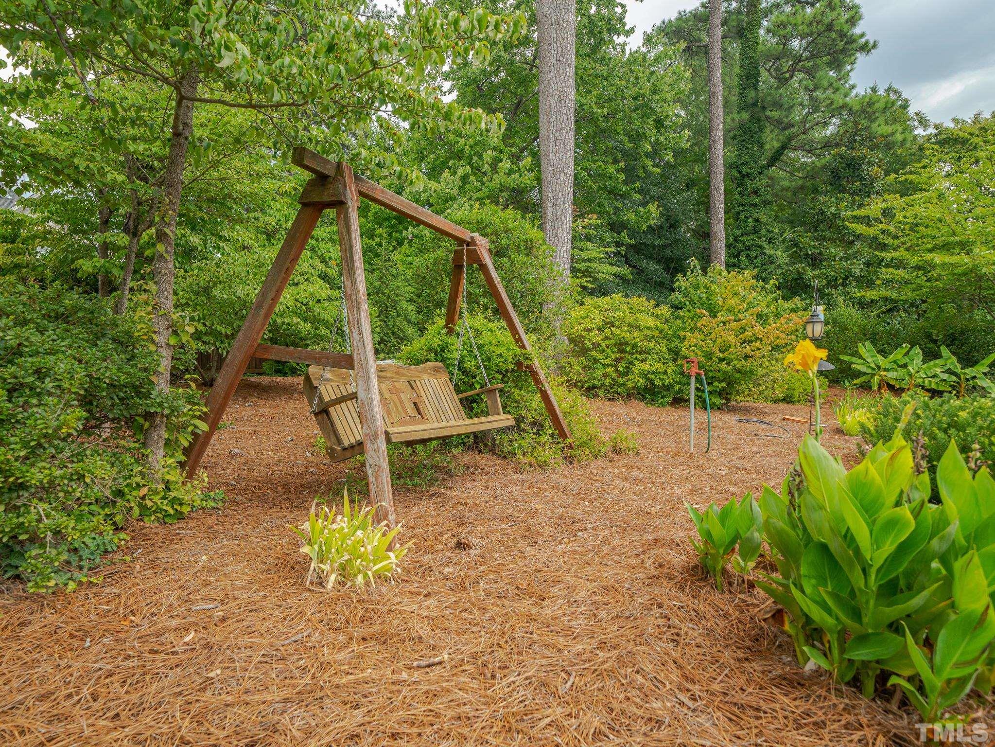 842 Cranbrook Road Raleigh, NC 27609 - Photo 38 of 39 a backyard of a house with table and chairs