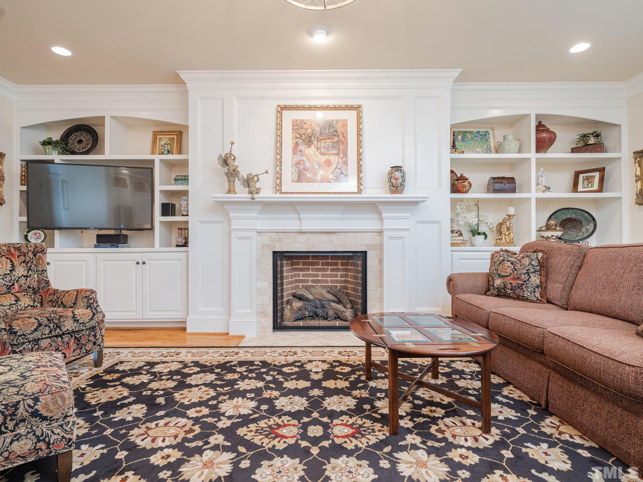 842 Cranbrook Road Raleigh, NC 27609 - Photo 7 of 39 a living room with furniture and a fireplace