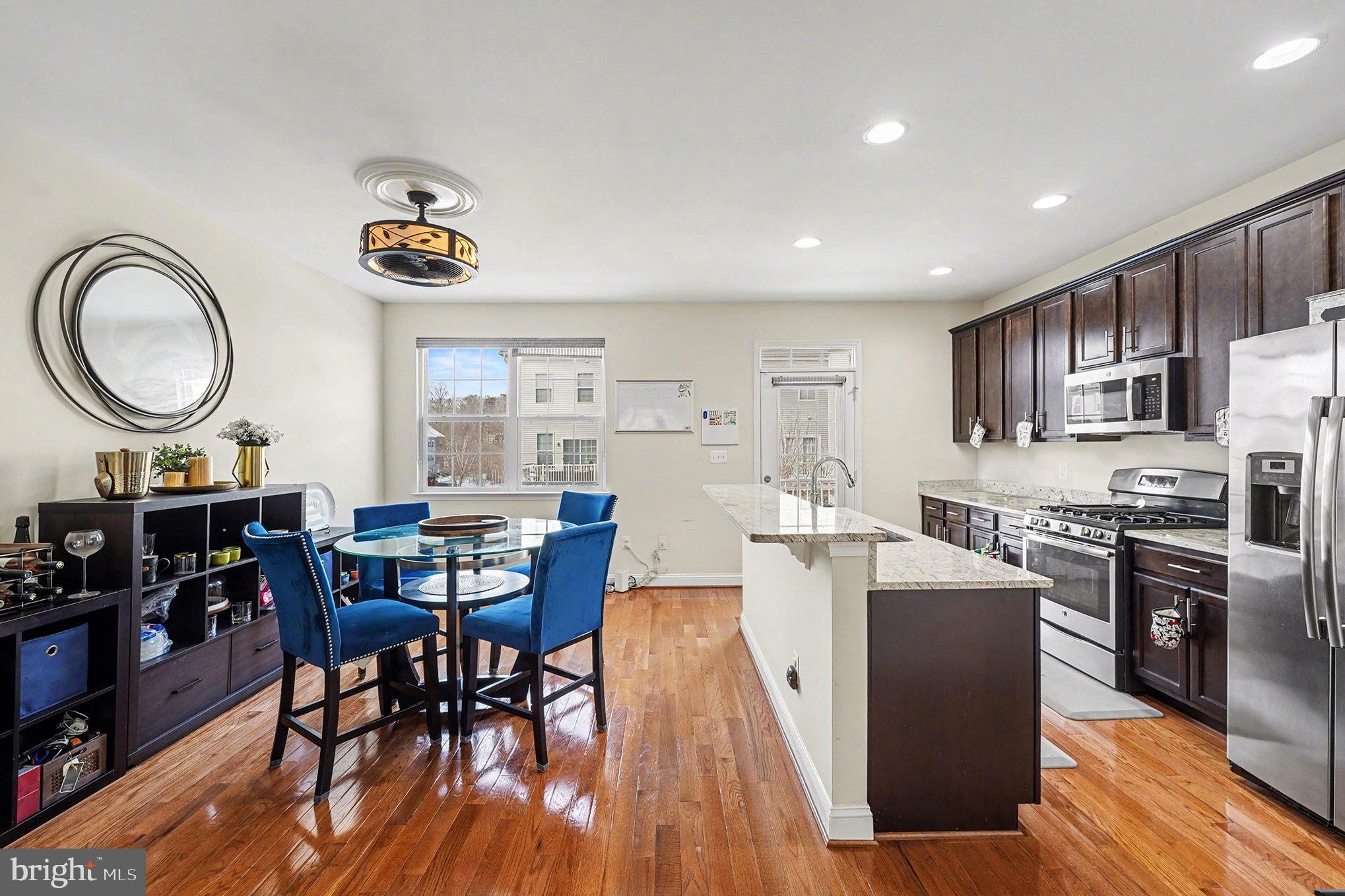 4440 Potomac Highlands Circle Triangle, VA 22172 - Photo 11 of 34 a large kitchen with lots of counter space a sink a dining table and chairs