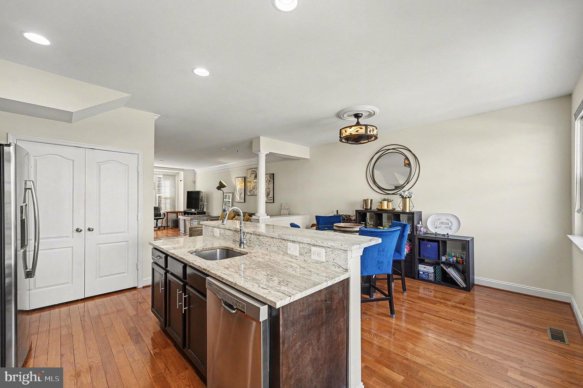 4440 Potomac Highlands Circle Triangle, VA 22172 - Photo 12 of 34 a view of kitchen island with wooden floor and cabinets