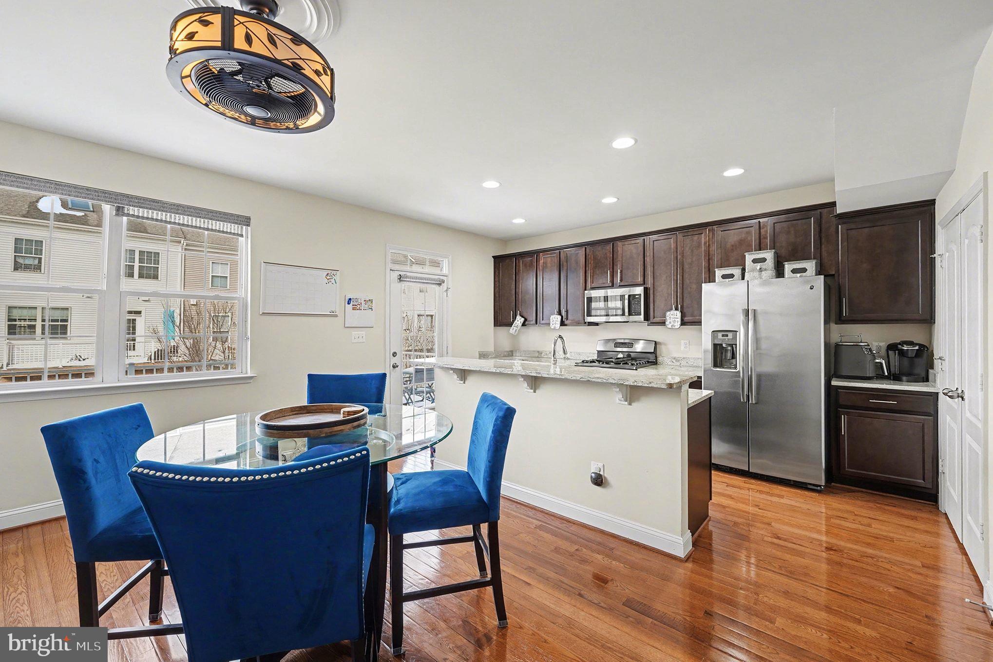4440 Potomac Highlands Circle Triangle, VA 22172 - Photo 14 of 34 a kitchen with stainless steel appliances granite countertop a stove a refrigerator a kitchen island a dining table and chairs