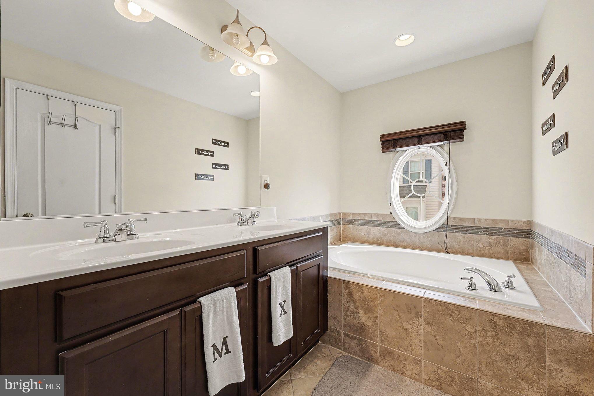 4440 Potomac Highlands Circle Triangle, VA 22172 - Photo 22 of 34 a bathroom with a sink and a mirror