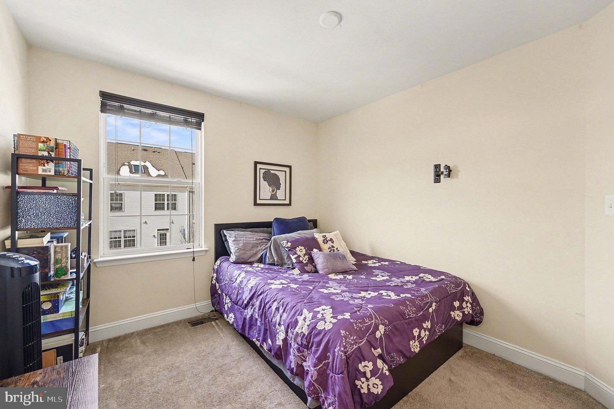 4440 Potomac Highlands Circle Triangle, VA 22172 - Photo 24 of 34 a bedroom with a bed and a book shelf