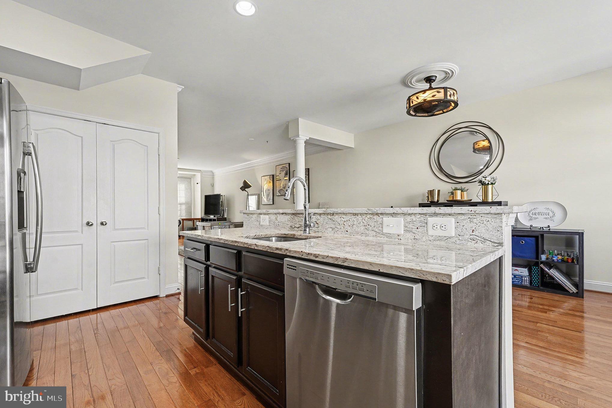 4440 Potomac Highlands Circle Triangle, VA 22172 - Photo 10 of 34 a kitchen with a sink cabinets and wooden floor