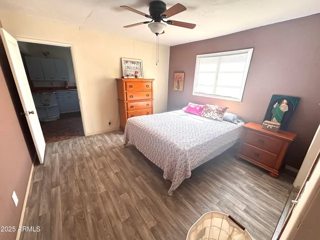 a bedroom with a bed and wooden floor
