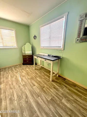 a room with wooden floor and a window