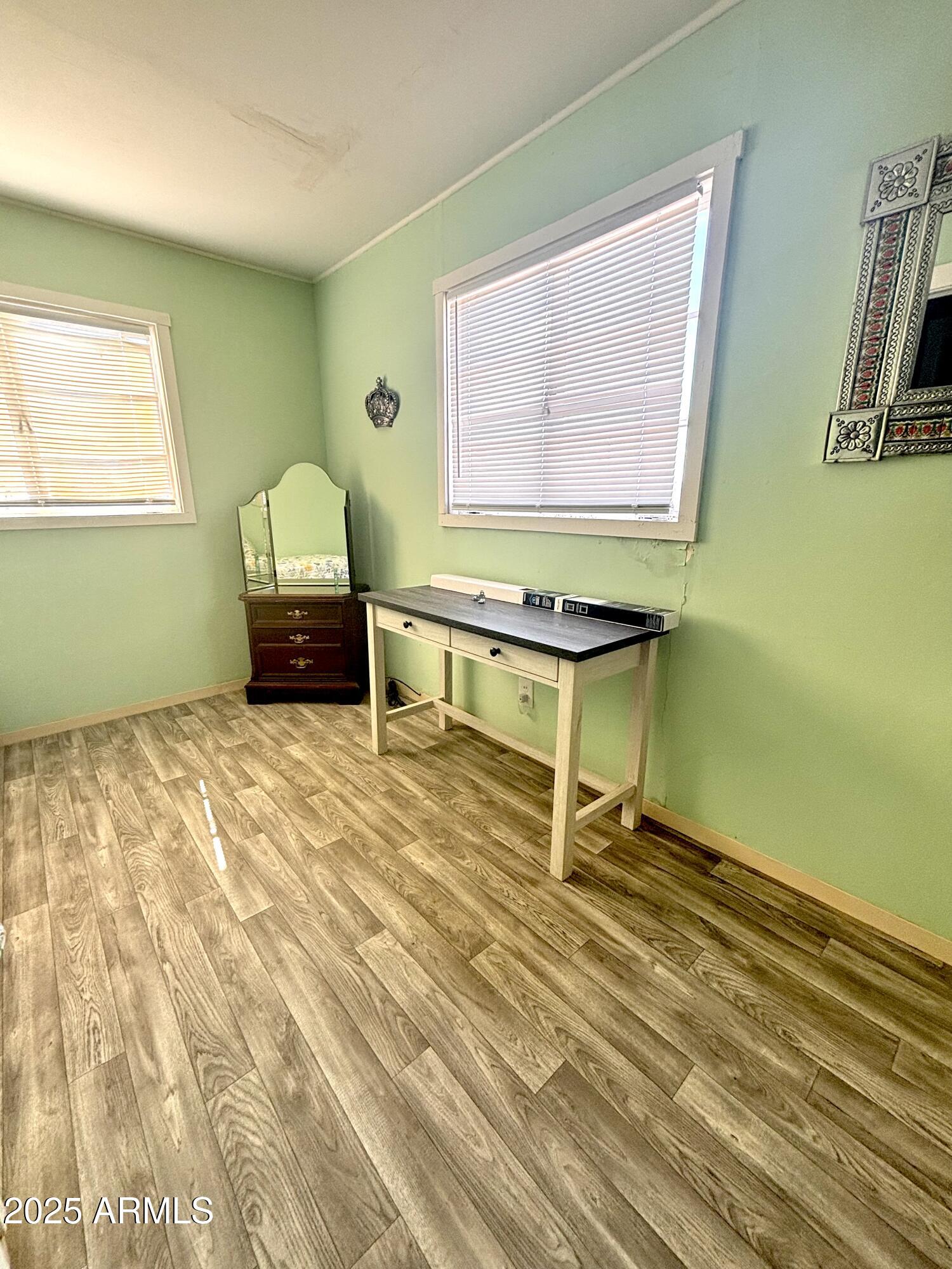 1540 North Jefferson Avenue Ajo, AZ 85321 - Photo 12 of 14 a room with wooden floor and a window