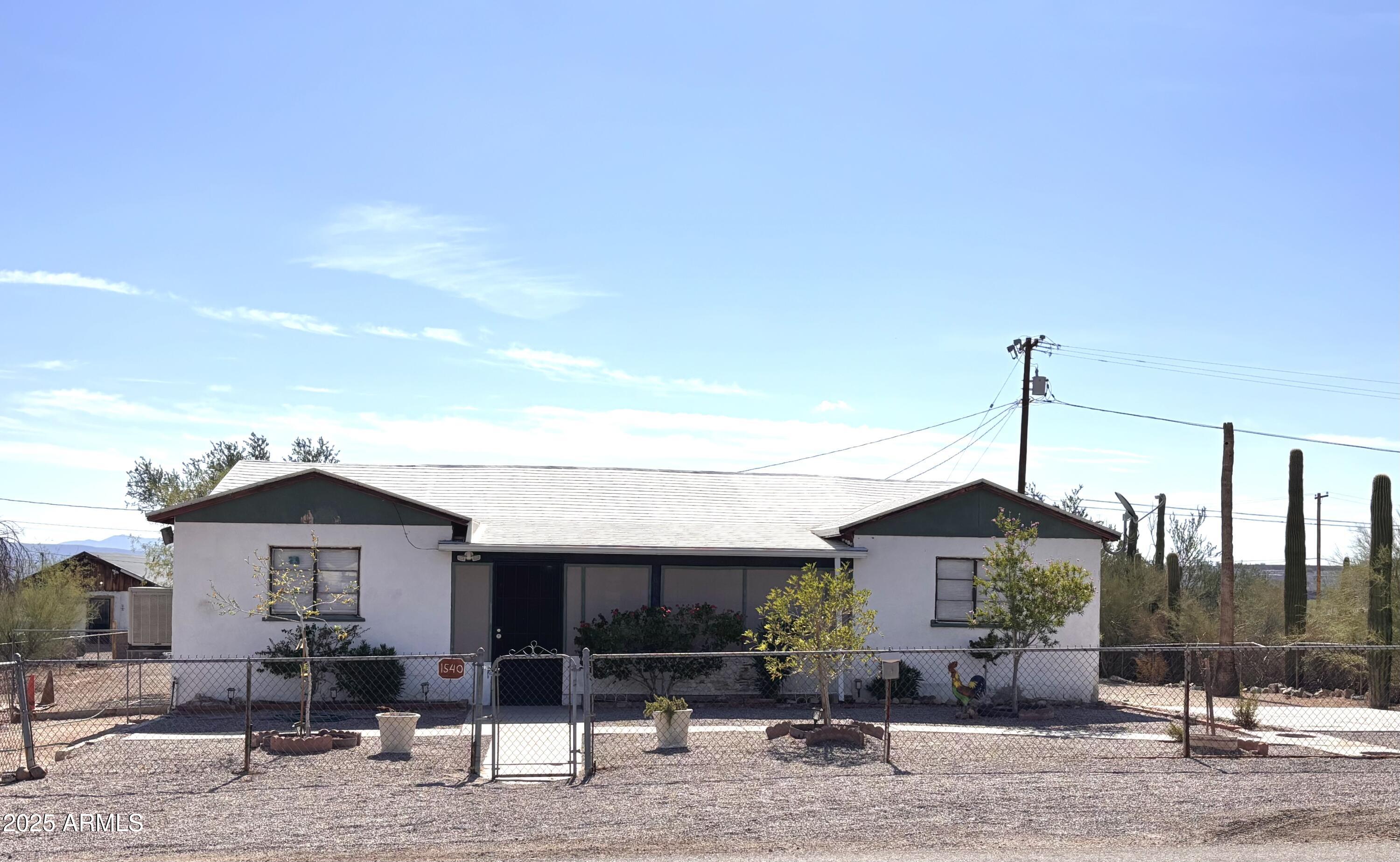 1540 North Jefferson Avenue Ajo, AZ 85321 - Photo 2 of 14 a front view of a house with garden