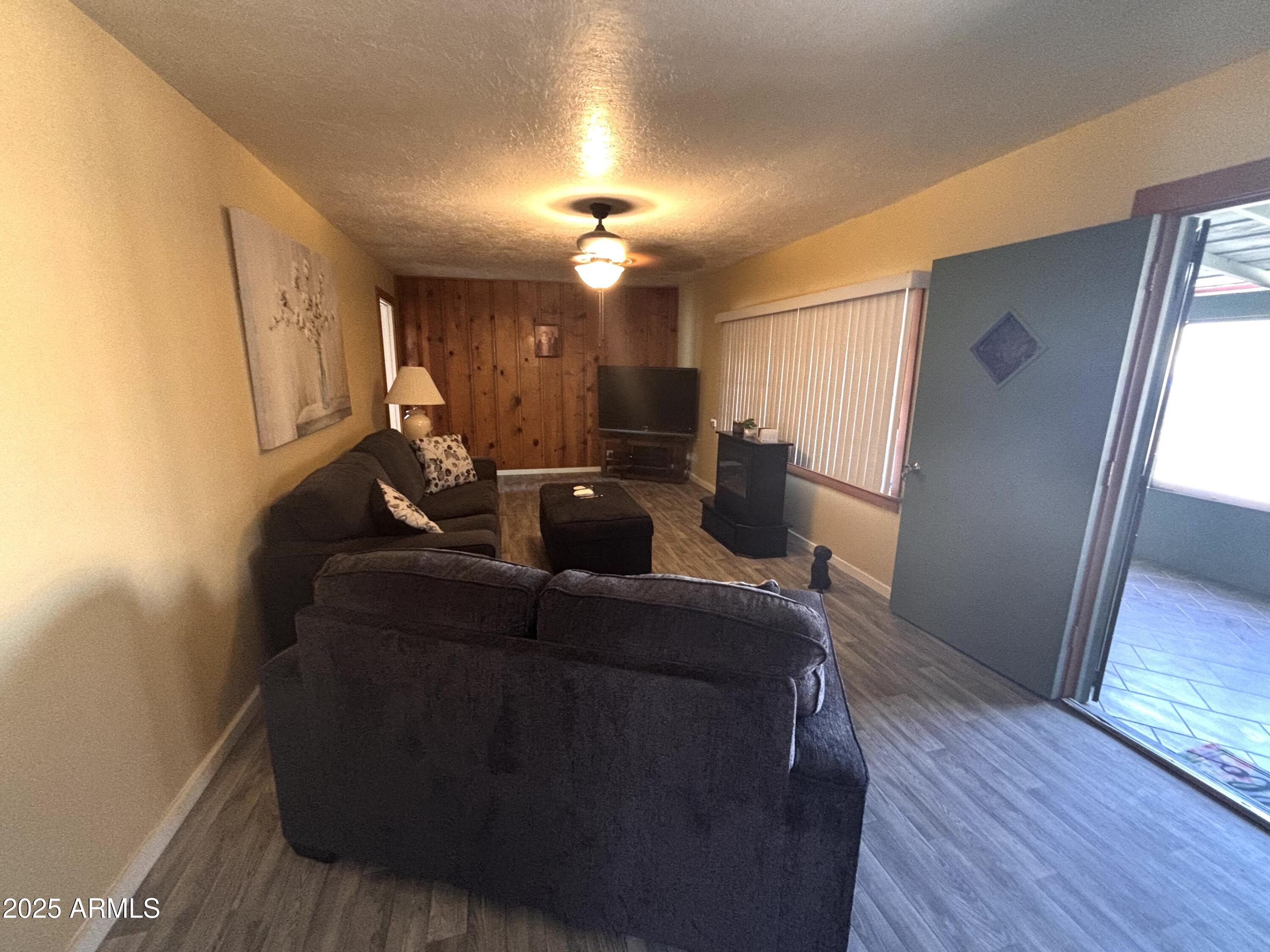 1540 North Jefferson Avenue Ajo, AZ 85321 - Photo 5 of 14 a living room with furniture and a chandelier