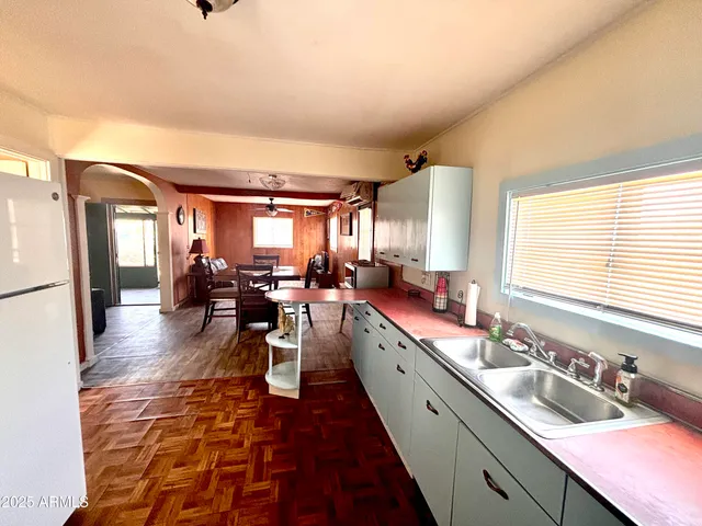 a large white kitchen with a large window