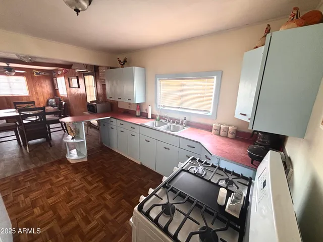 a kitchen with a sink stove and cabinets
