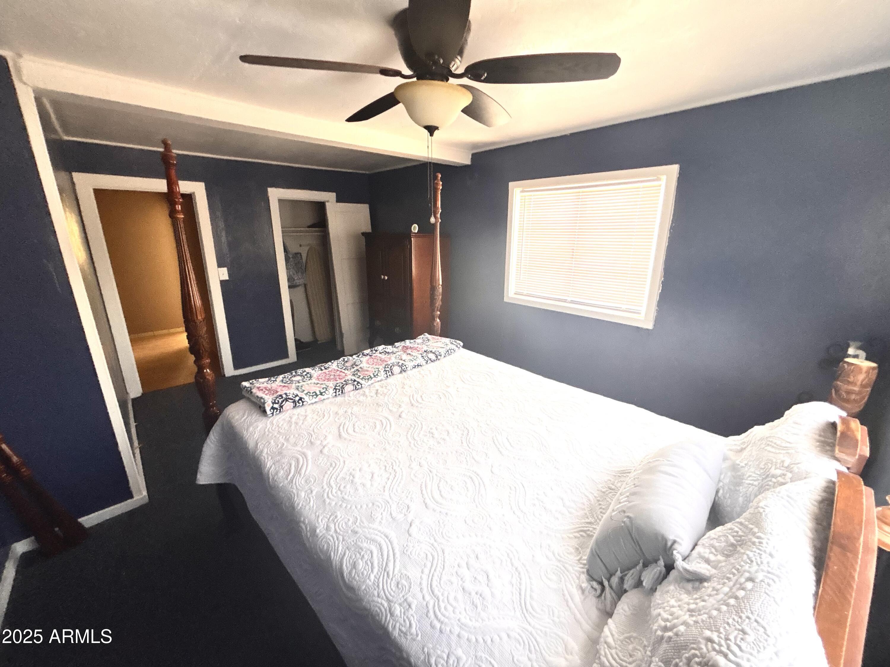 1540 North Jefferson Avenue Ajo, AZ 85321 - Photo 10 of 14 a bedroom with a large bed and a large mirror