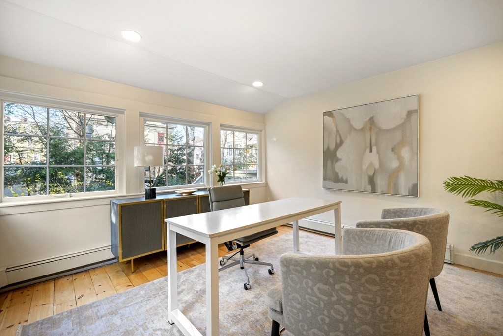 105 Eldredge Street Newton, MA 02458 - Photo 12 of 42 a dining hall with stainless steel appliances granite countertop a sink a counter space and living room view