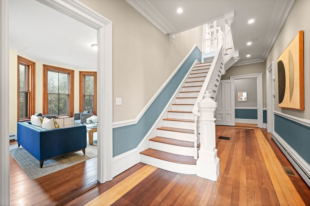 105 Eldredge Street Newton, MA 02458 - Photo 15 of 42 a view of a living room with wooden floor and windows