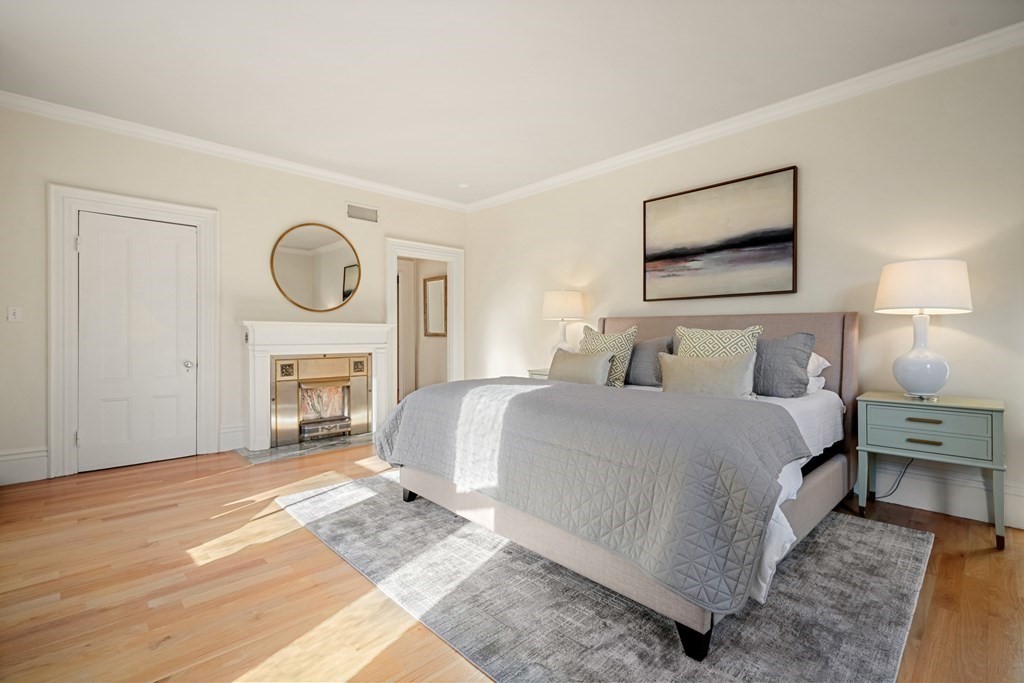 105 Eldredge Street Newton, MA 02458 - Photo 17 of 42 a bedroom with a bed and a fireplace
